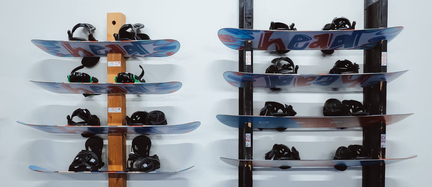 Snowboards and bindings racked on the wall