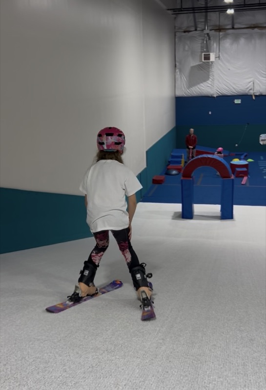 Girl skiing toward obstacle course at Shredder Lafayette