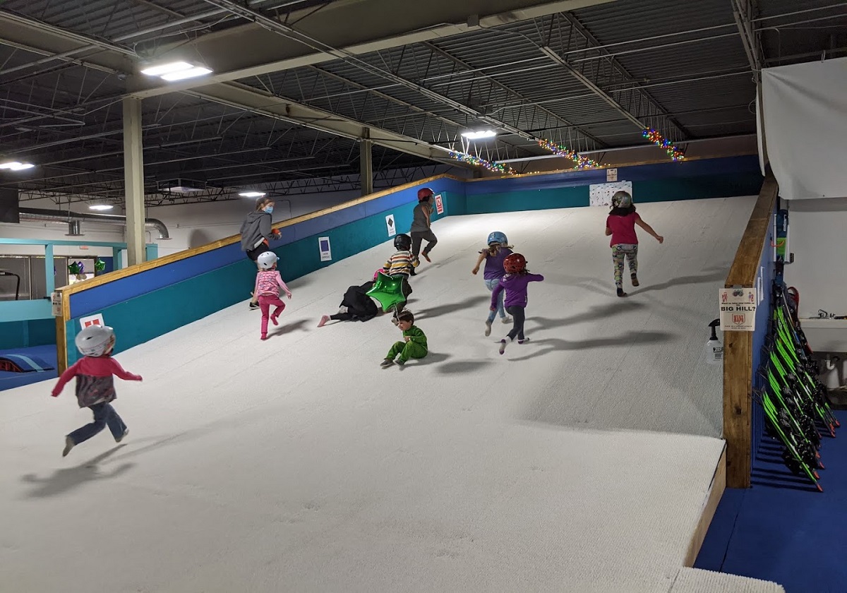 Kids running and playing on the slope at Shredder summer camp