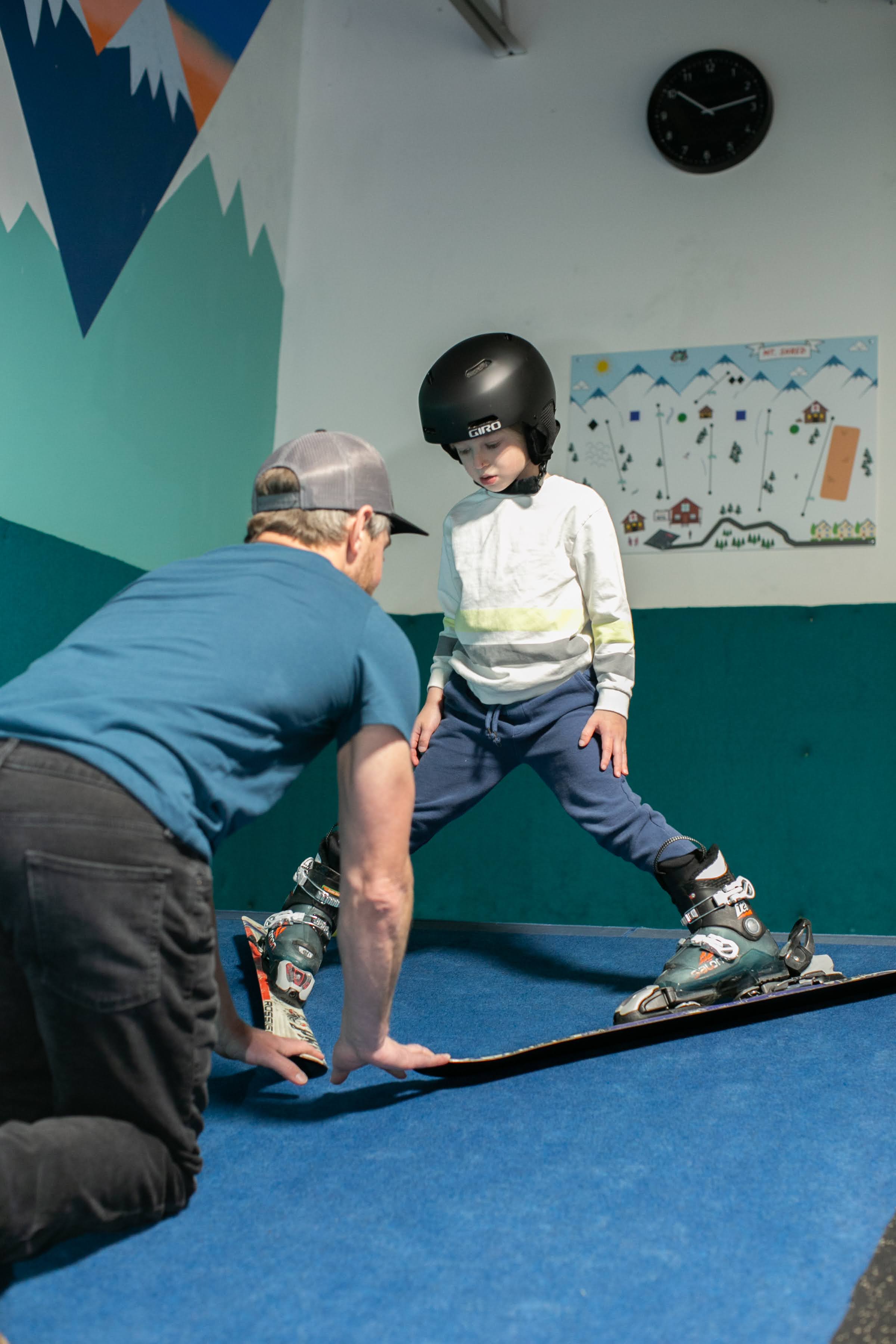 Instructor giving private ski lesson to child at Shredder