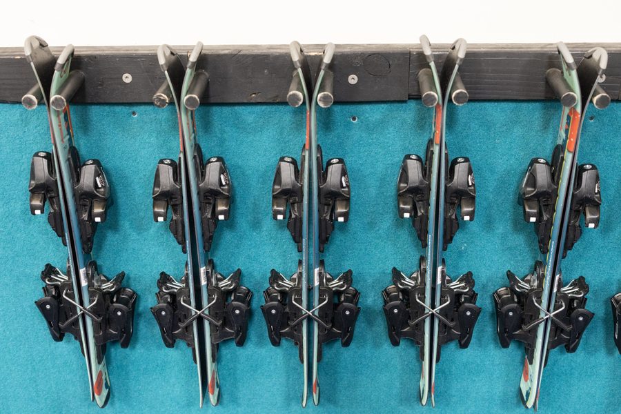 A wall of ski bindings mounted and ready