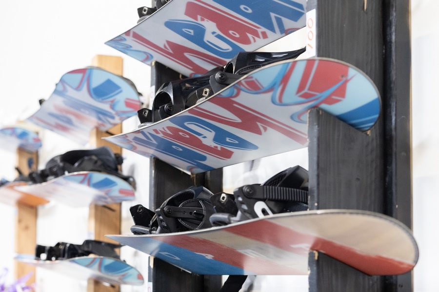 Snowboards racked and ready on the shop wall