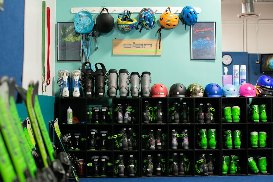 Helmets and boots sorted by size on the gear wall
