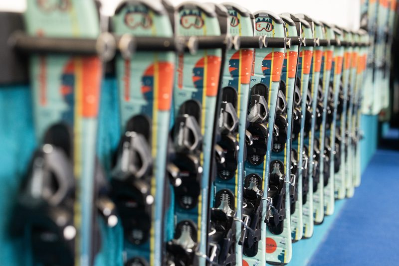 A rack of fitted Shredder skis and poles ready for a session