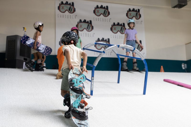 A young rider steering through a training arch at Shredder Wheat Ridge